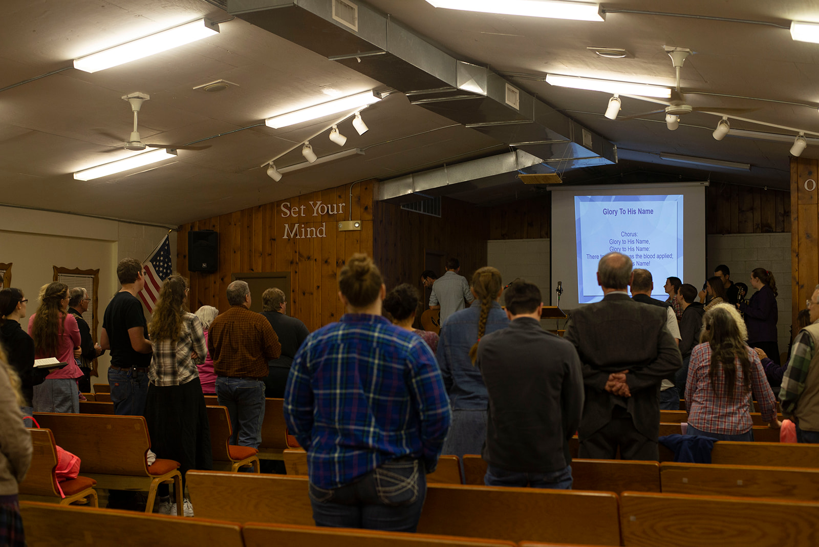 A group of people sing together.