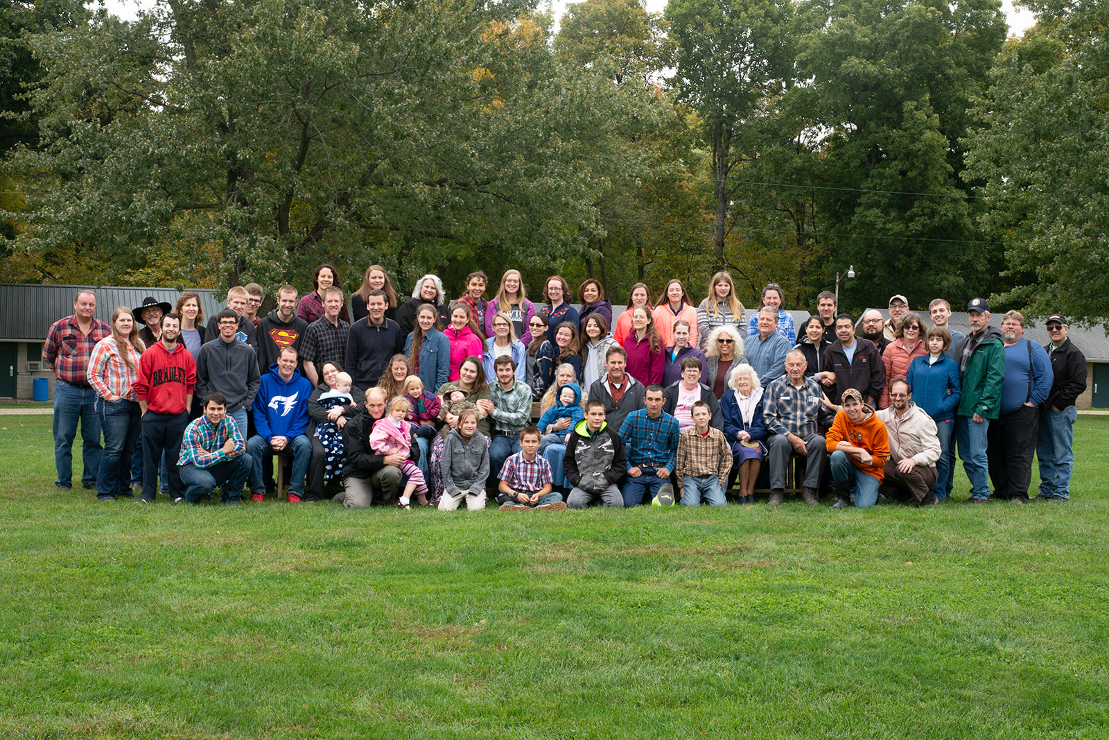 A group of people stand in front of a chapel.